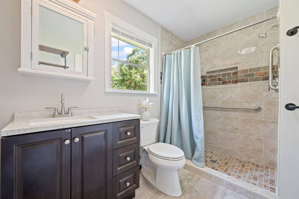 The bathroom is wheel chair accessible with new cabinetry, flooring, toilet, shower with handrail, etc...
