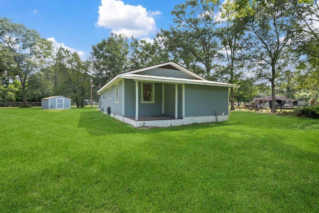 The back of the home has a sweet little porch for early morning coffee and to look at all of the back pasture.