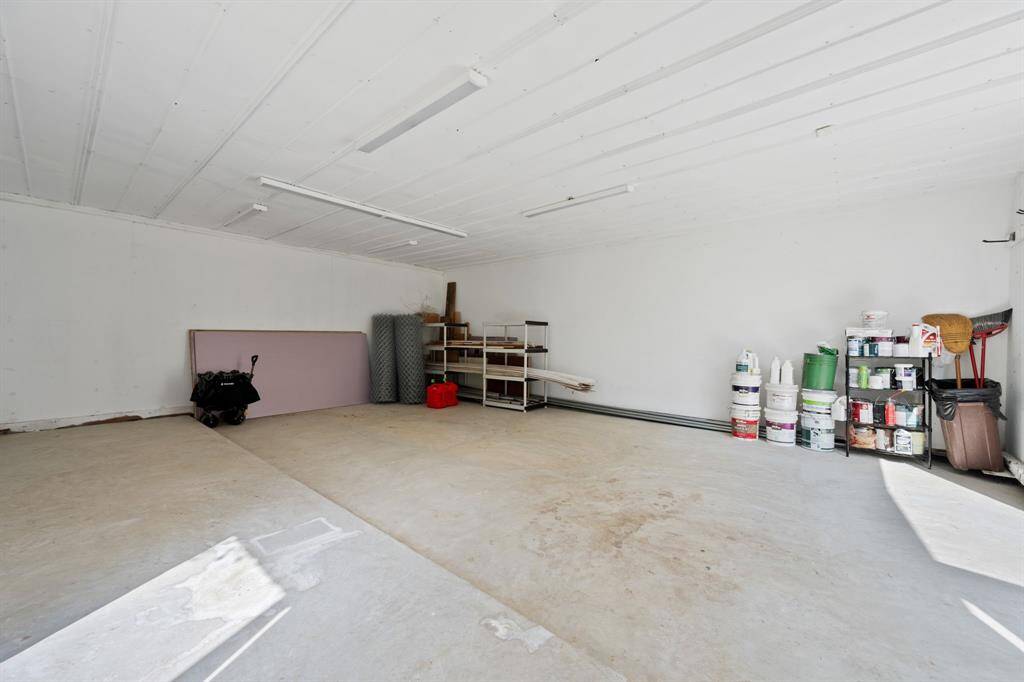 Garage/ Workshop is ready for cars or tools.  This has a brand new concrete floor. This space is also cooled by a window unit and has double doors.