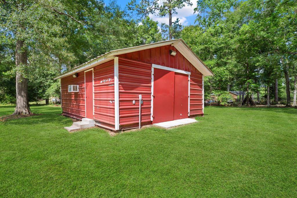 This beauty has a garage/workshop with a brand new concrete floor installed. It has double doors to fit approximately 4 cars in, or two cars and space for tools. It does have a window unit to cool you down during the summer months.... and would be a great location for cookouts!