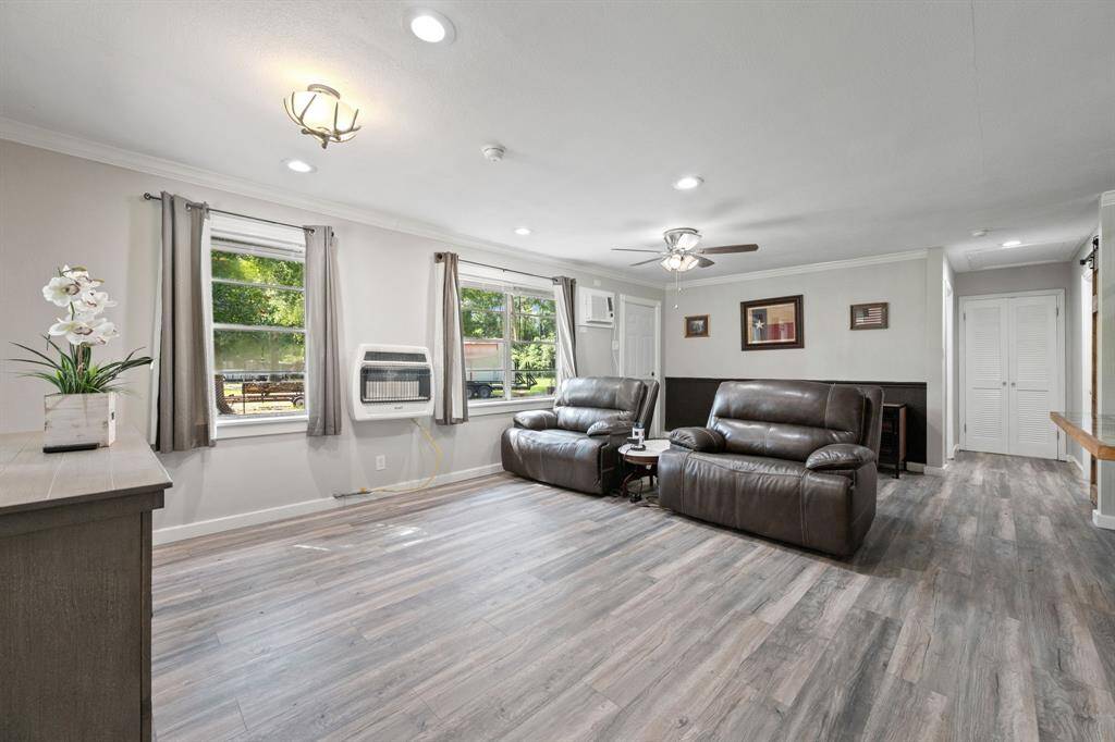 The two window units in this home also have heaters, then there is a gas wall heater as well. New windows, new doors, new trim, new flooring, everything is new! You have plenty of space for a regular sized couch as well.