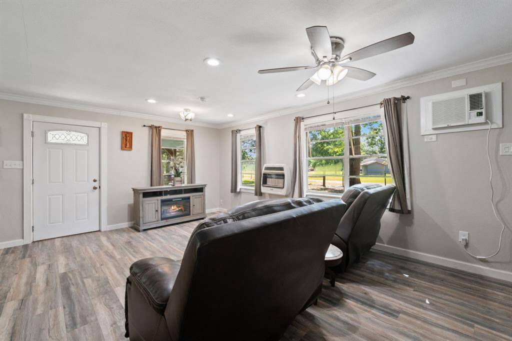 Look at all of the natural light that flows in from these gorgeous windows. It's a lovely space with LVP flooring for durability and longevity. Also has brand new trim, lighting, and fan.