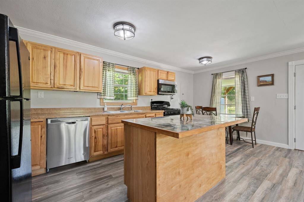 Love this sweet kitchen.  New laminate counters, new cabinetry, new appliances, new flooring, lighting, trim... etc.