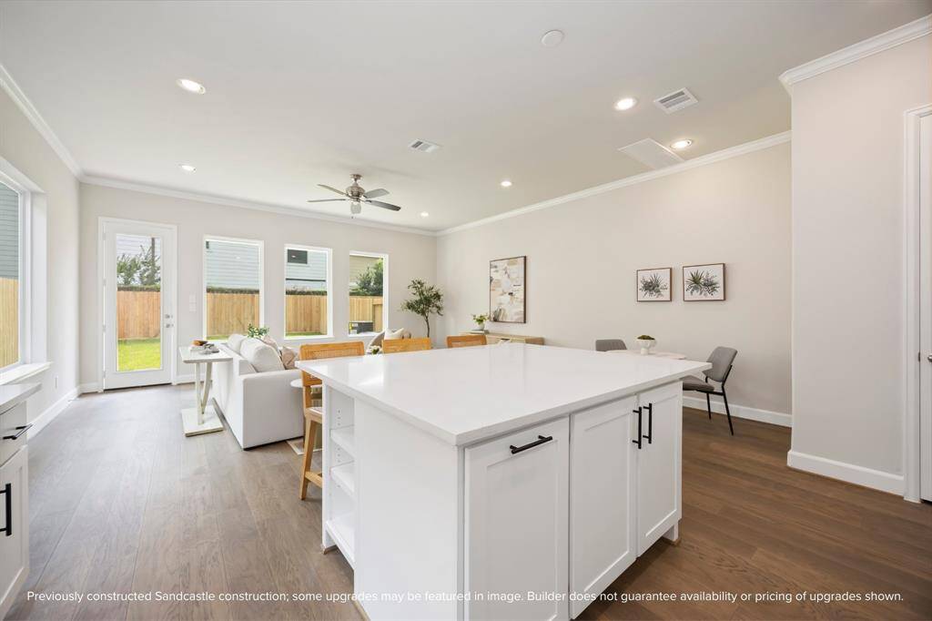 This huge island offers adjustable shelves, perfect for storing cookbooks or frequently accessed items, while providing a stunning view of the entire open-concept first-floor living space.