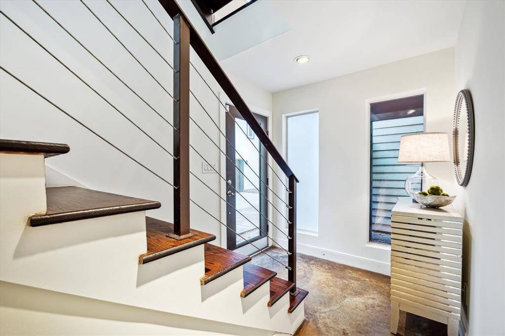 FRONT ENTRY. As soon as you step inside, you will see how different this townhome is with its many windows. The front entry is bright with a view out to the private patio.
