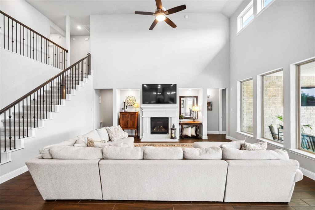 The left of the fireplace leads to the mudroom, half-bath and laundry room. The right leads to the primary bedroom.