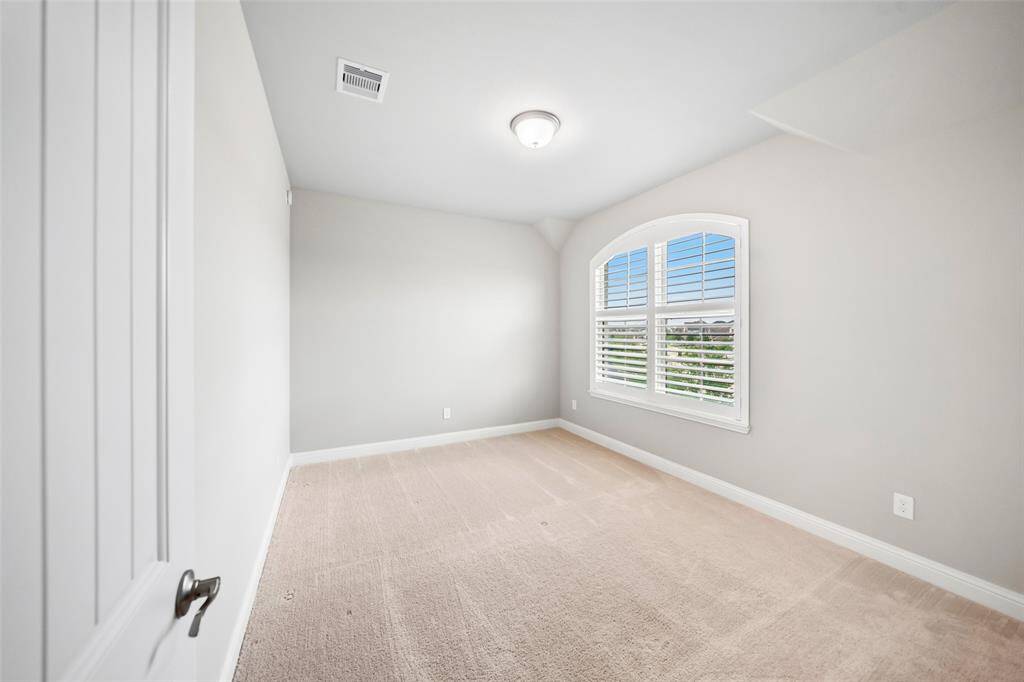2nd secondary bedroom features a large window with plantation shutters with views to the lake in front of the house. It also has a large walk-in closet with its own window.