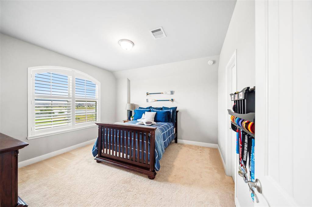 3rd secondary bedroom also features large window with plantation shutters overlooking the lake and a large walk-in closet.