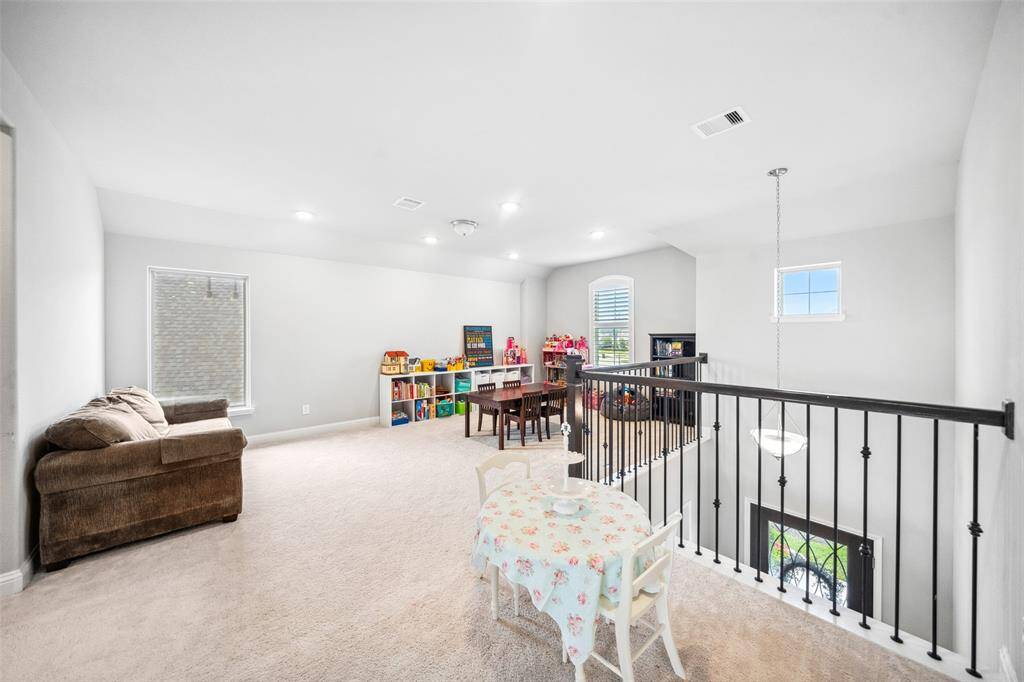 Gameroom open to foyer and great room below includes a small storage closet to the right in this picture.