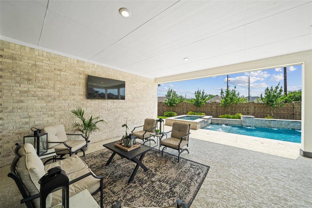 Enjoy outdoor living year-round with this Texas-sized patio! TV mount and dedicated electrical outlet on wall (TV not included)