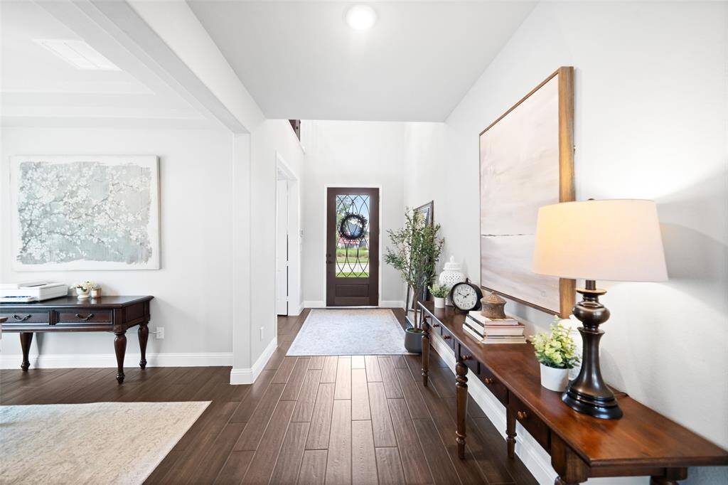 Enter the house through the over-sized 48"-wide door into the 2-story foyer.