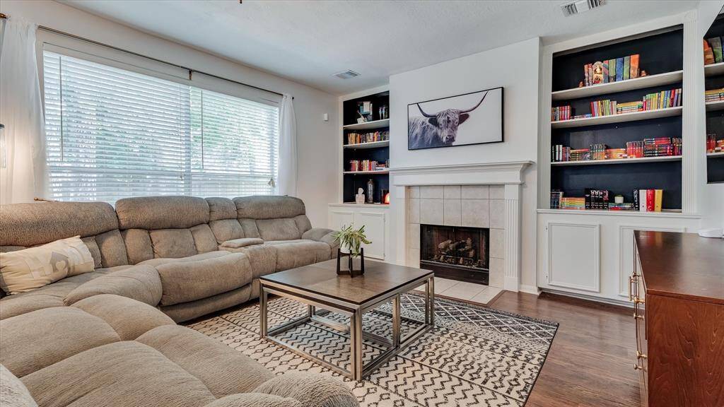 Family room with built-in cabinets and gaslog fireplace.