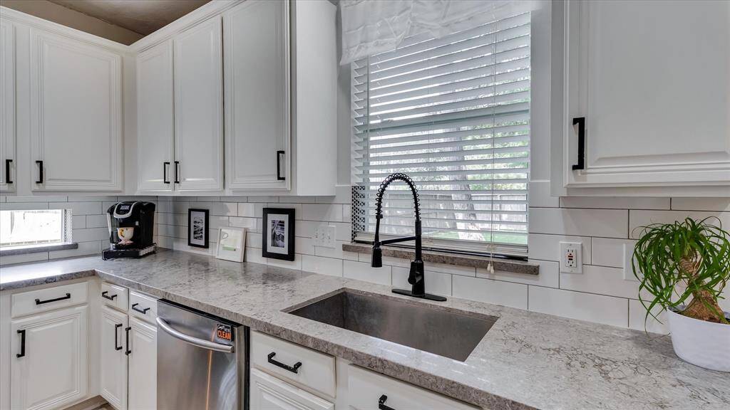 Quartz countertops and undermount sink with subway backsplash.