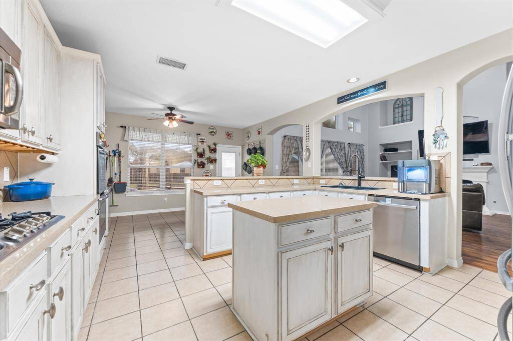 The breakfast room is adjacent to the kitchen.  Windows overlook the backyard/pool.