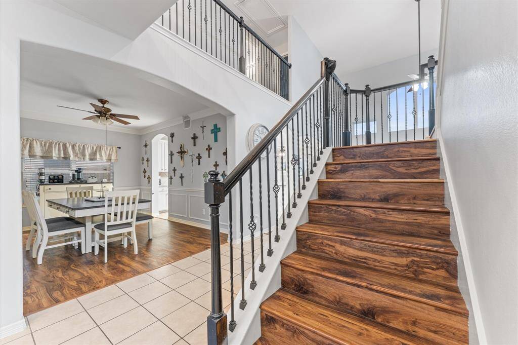 Staircase with wrought iron balusters.  No carpet on the stairs is an added bonus.
