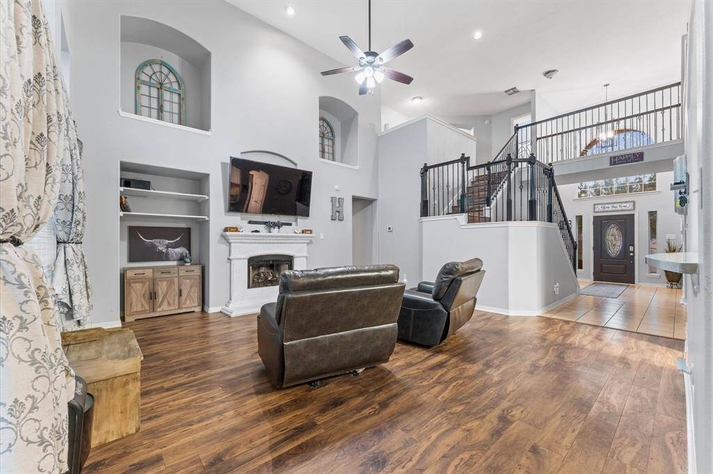Den with soaring ceilings.  Flat screen mounted TV stays with the home.