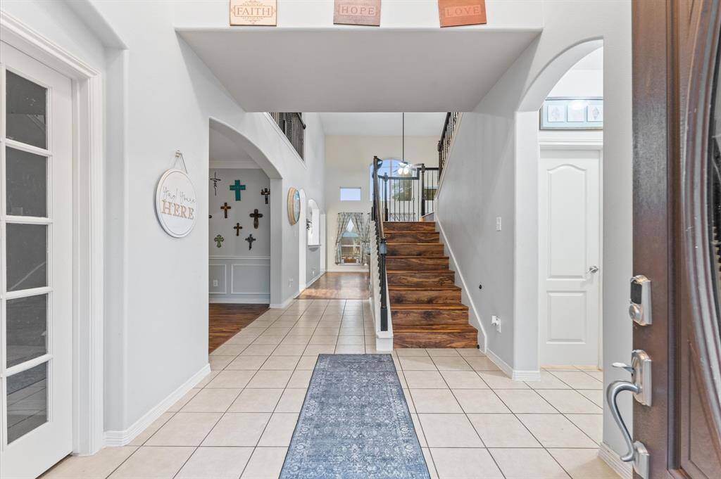 Den w/ beautiful windows overlooking the pool.  Lots of built-ins.   Cast stone fireplace.  Upgraded wood laminate floors.  Not only are they beautiful but easy to care for.  Den with beautiful windows overlooking the pool. There are many built-ins and a cast stone fireplace. Upgraded wood laminate floors are not only attractive but also easy to maintain.