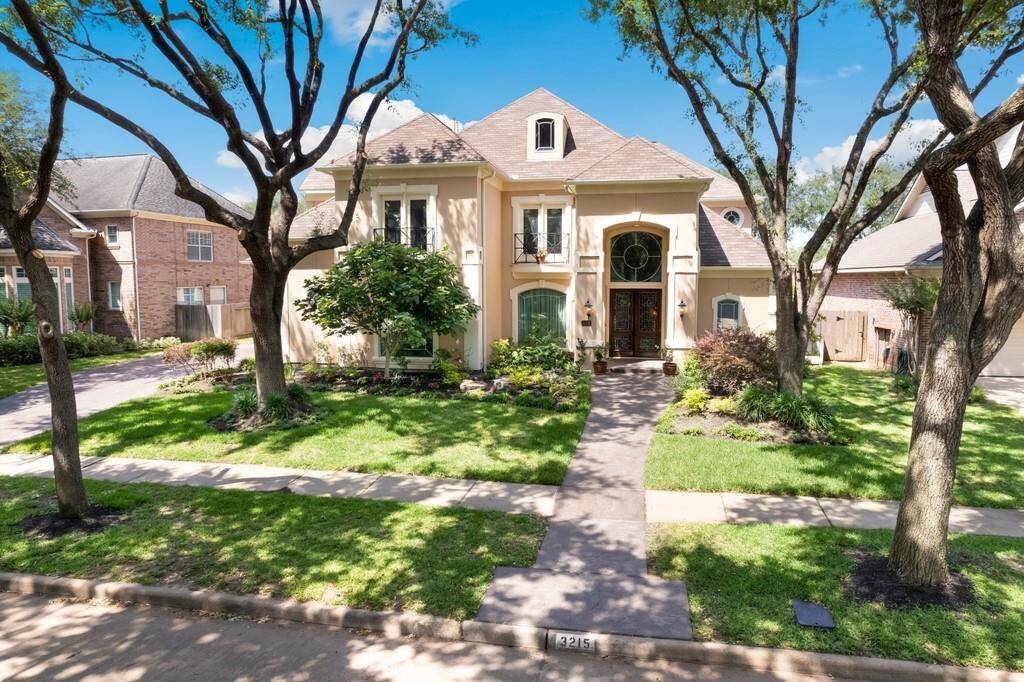 Stunning curb appeal with a French-inspired façade, arched entryway, and manicured landscaping. Nestled beneath mature trees, this stately home blends elegance and privacy in one of Sugar Land’s most coveted golf course neighborhoods.