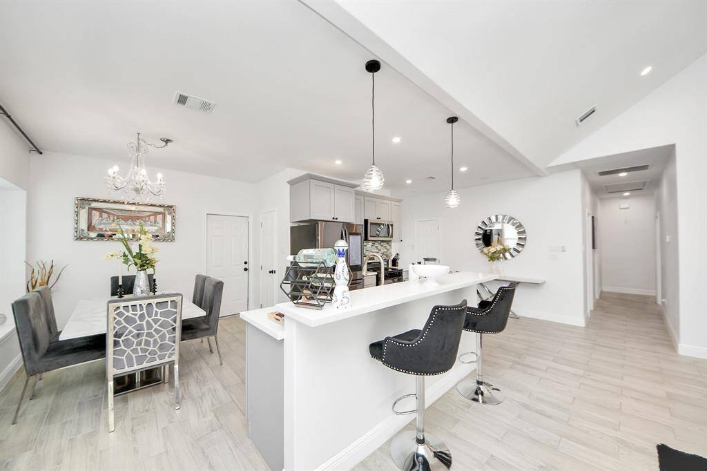 Open kitchen with bar area and dining room.