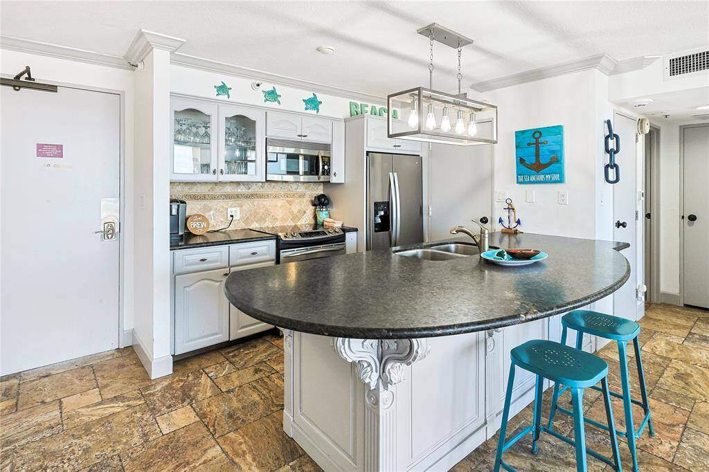 Welcome to the kitchen!  Imagine making meals while looking at the expansive 10th Floor views of the Gulf!  This beautiful updated kitchen offers stunning coutnertops, plenty of storage and gorgeous lighting.