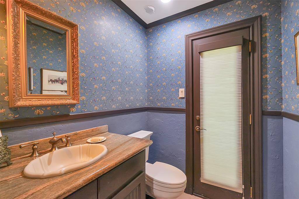 Powder room with door to back yard and pool area