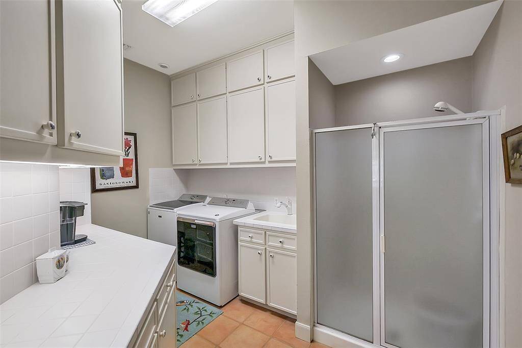 Huge Laundry room with tons of extra storage and even a full shower