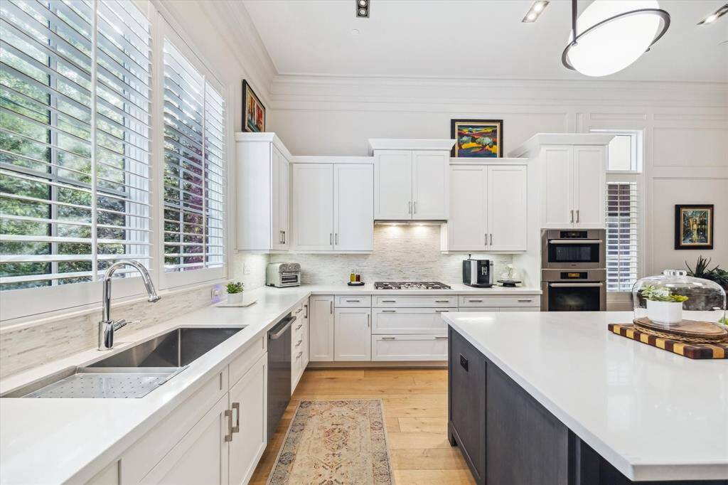 The large windows in the kitchen provide an abundance of natural light and overlook the lovely backyard courtyard space.