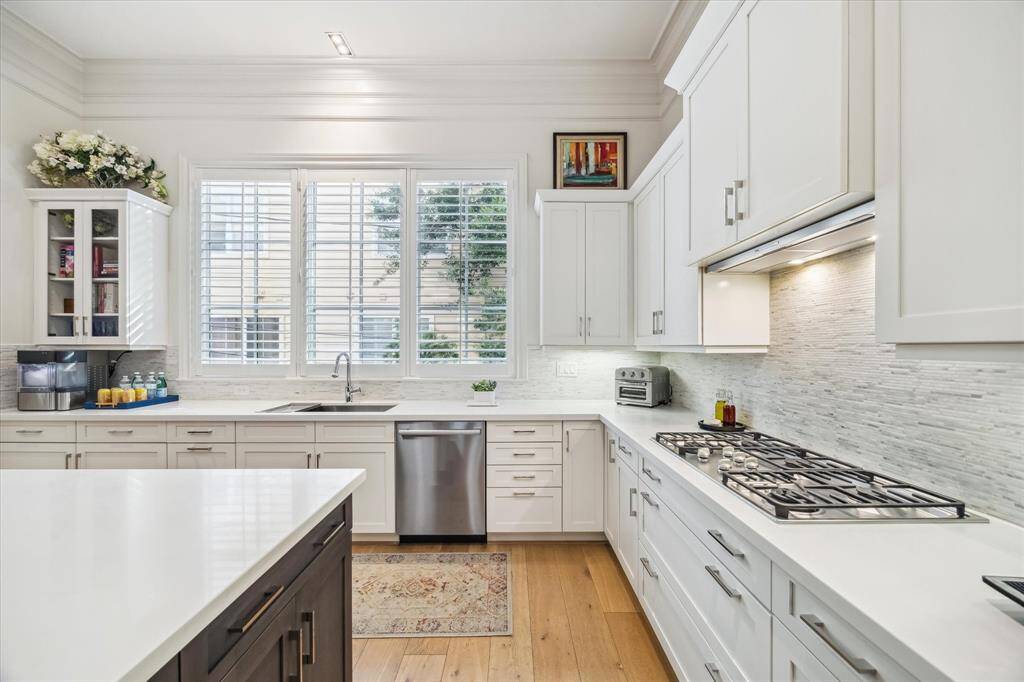 Lovely and functional - this kitchen features high-end finishes, clean lines, and an open layout perfect for both everyday living and effortless entertaining.