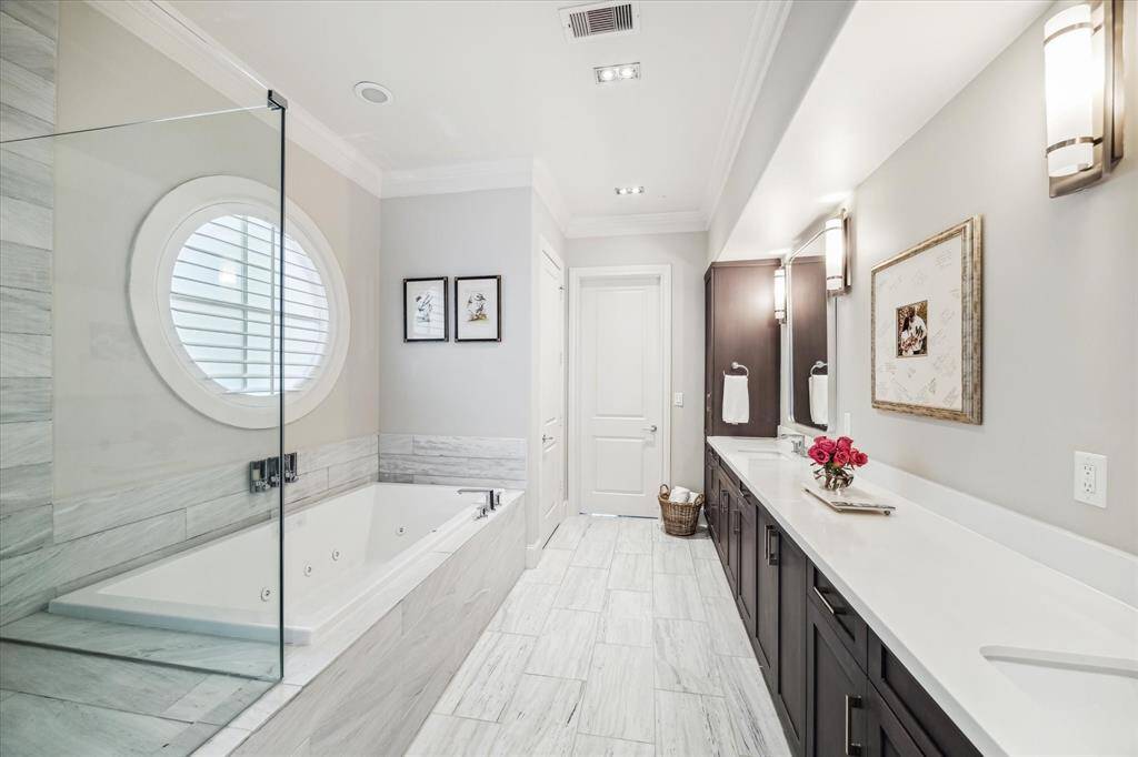 The primary bath showcases a jetted soaking tub and double sinks, along with a private water closet.