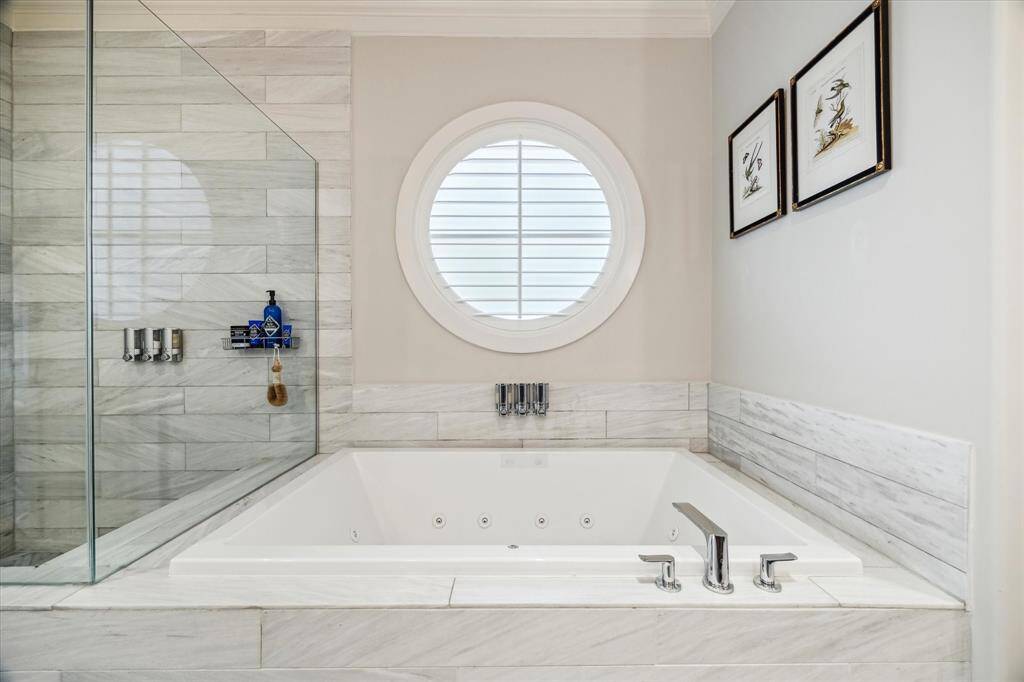 The relaxing soaking tub is located adjacent to the oversized enclosed shower.