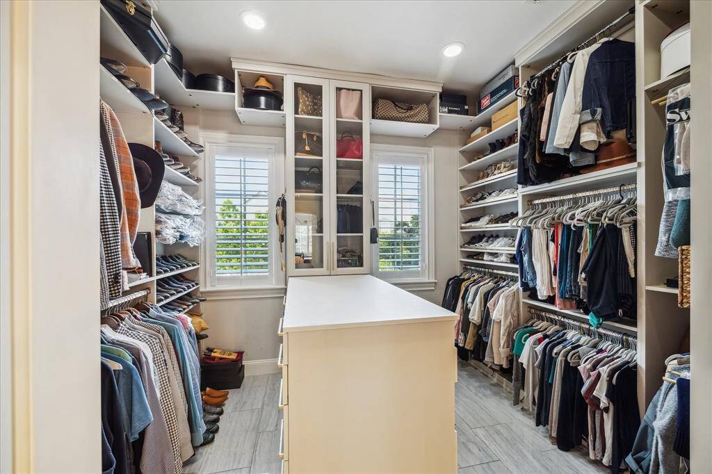 The primary closet is a dream come true!  Recently upgraded with a custom California Closet system, there are plenty of thoughtful storage solutions for all of your clothing, shoes, bags, boots, hats and more!