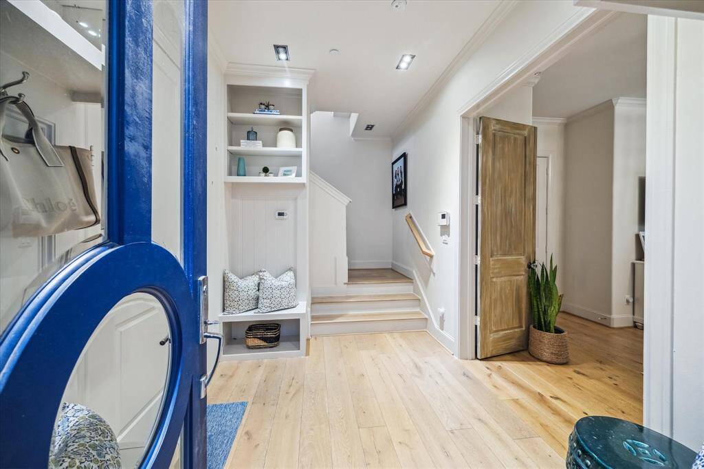 The foyer, accessed both from the front door and the garage (with epoxy floors) provides an abundance of space and a welcoming place to return home.  The stunning wide-plank white oak floors run throughout the entirety of the home.