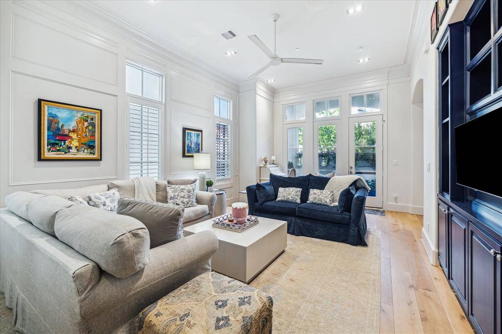 The second level boasts soaring 12-foot ceilings in the open-concept living area, with access to the balcony through a screened door—creating a seamless flow between indoor comfort and outdoor living.