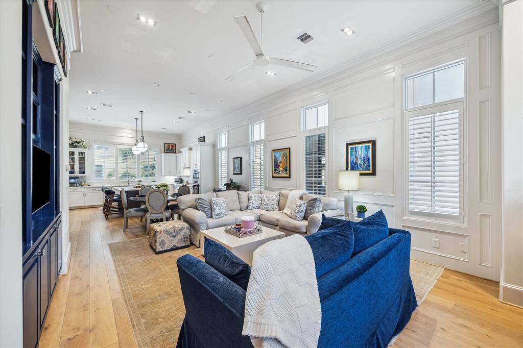 The living, dining, and kitchen areas flow effortlessly together, creating an inviting space ideal for entertaining.