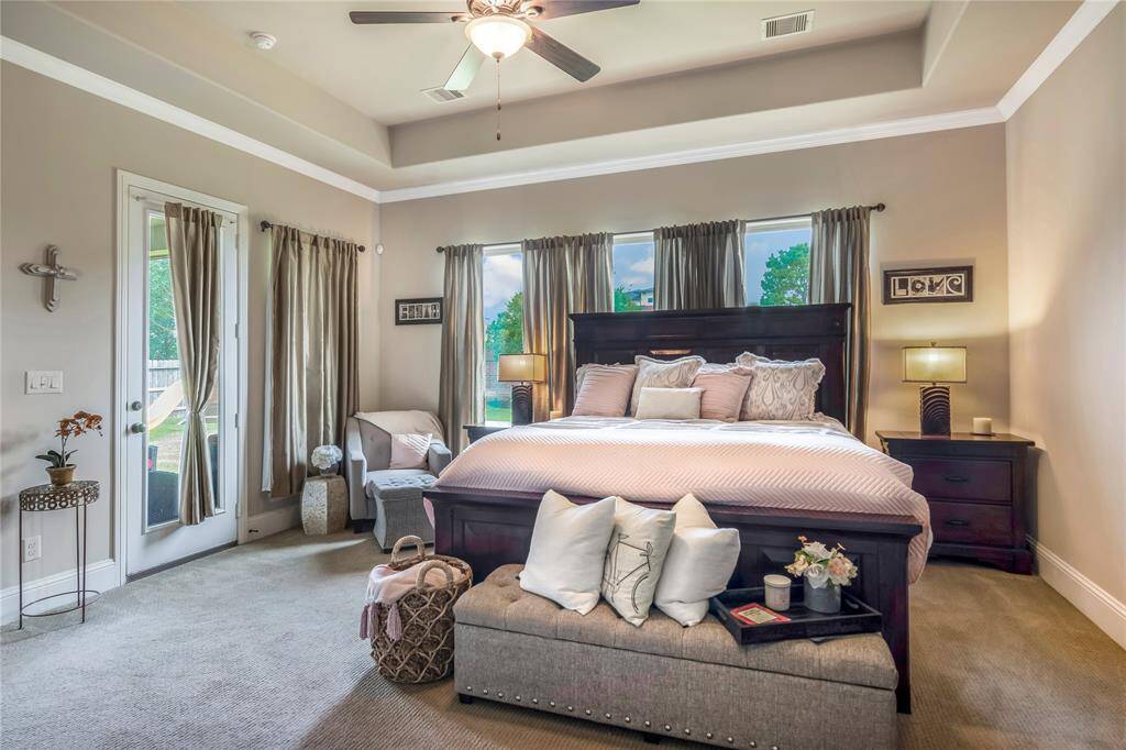 Spacious primary bedroom, with door to back patio