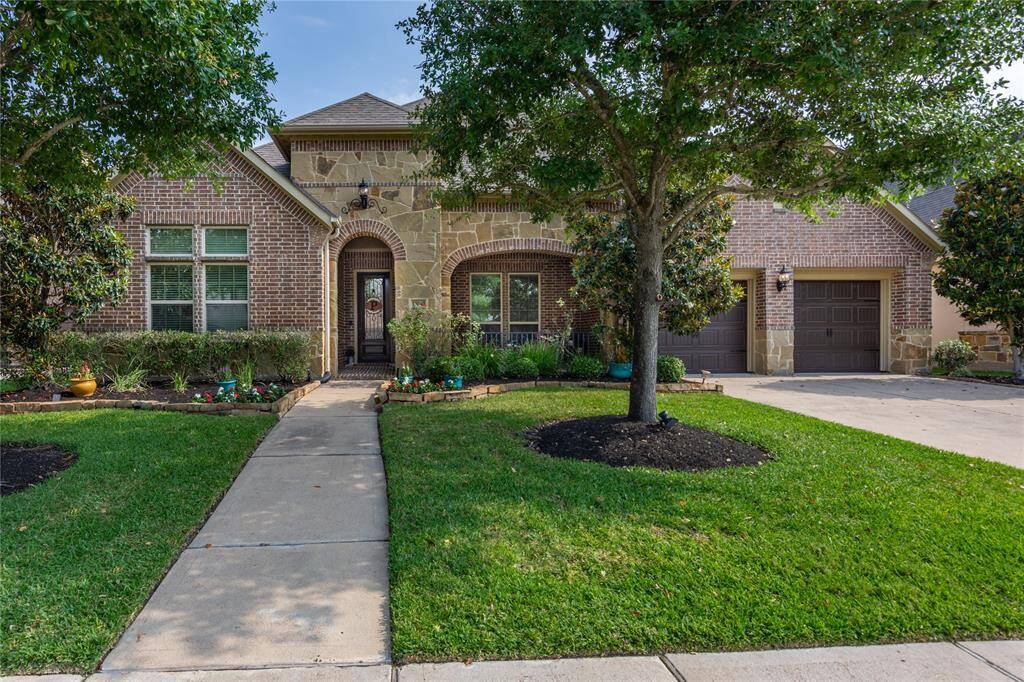 Elegant brick and stone home with and a welcoming front porch.