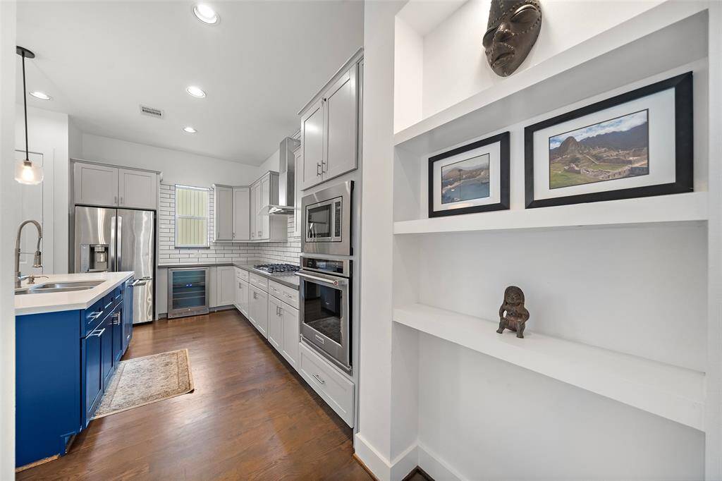 2nd Floor: Kitchen, Living/Dining, Utility Room, Half-bath, Small Patio