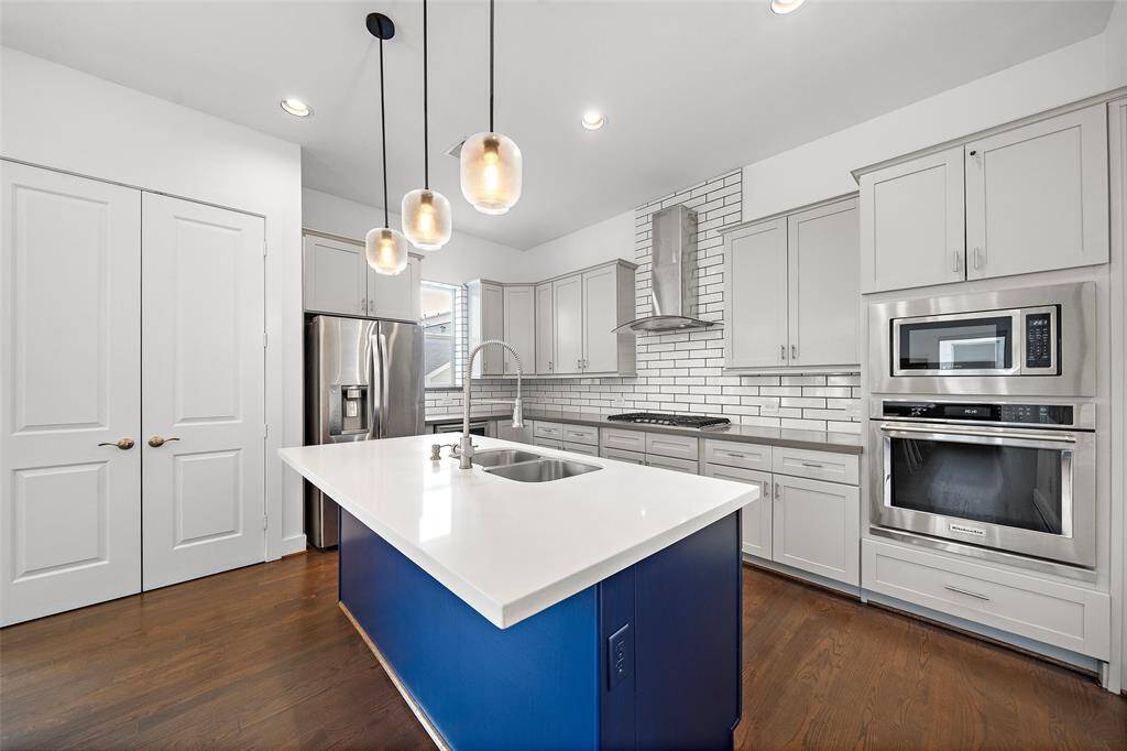 2nd Floor: Kitchen, Living/Dining, Utility Room, Half-bath, Small Patio