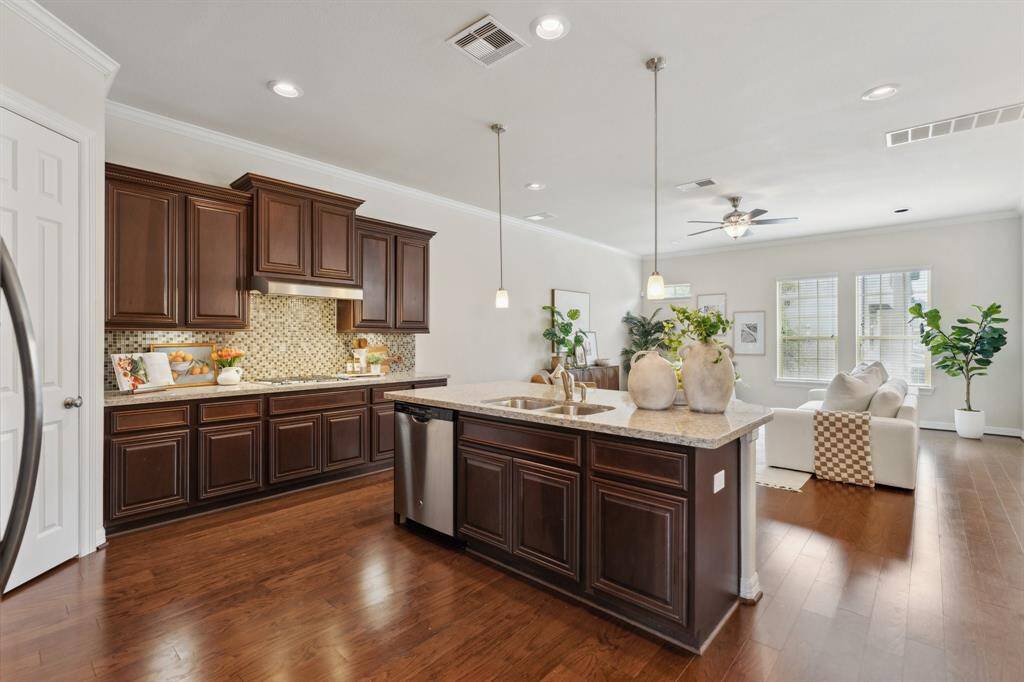 It features a breakfast bar, luxurious finishes, and a large island.