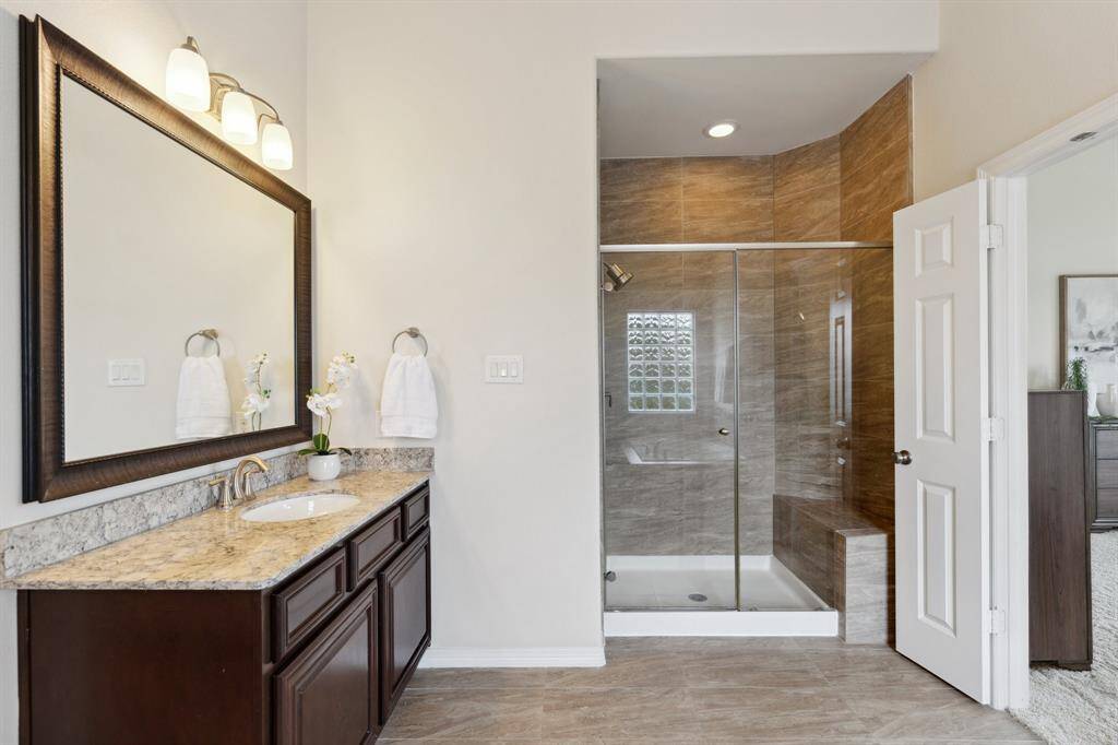 Designed with both luxury and function in mind, the large shower includes a built-in bench.