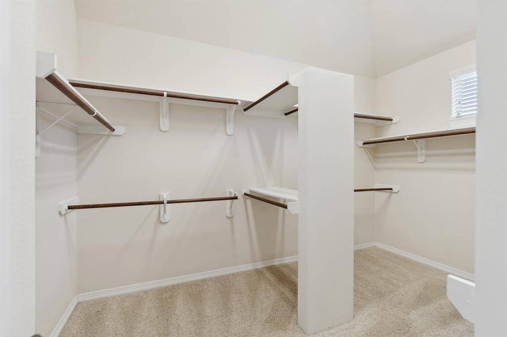 Enjoy the luxury of a large walk-in closet in the primary bedroom, offering abundant hanging space and room to spare.