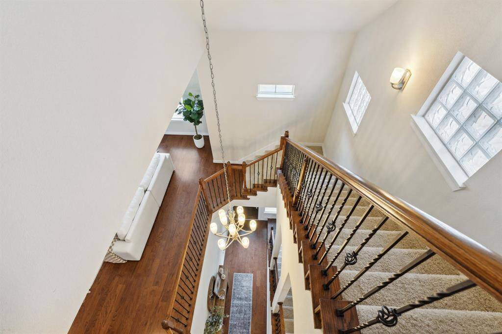 At the top of the stair case you will find a laundry room and large storage closet. A like new Samsung AI washer and dryer are included with the home! The well-lit staircase guides you smoothly back through the second floor and onto the first floor.