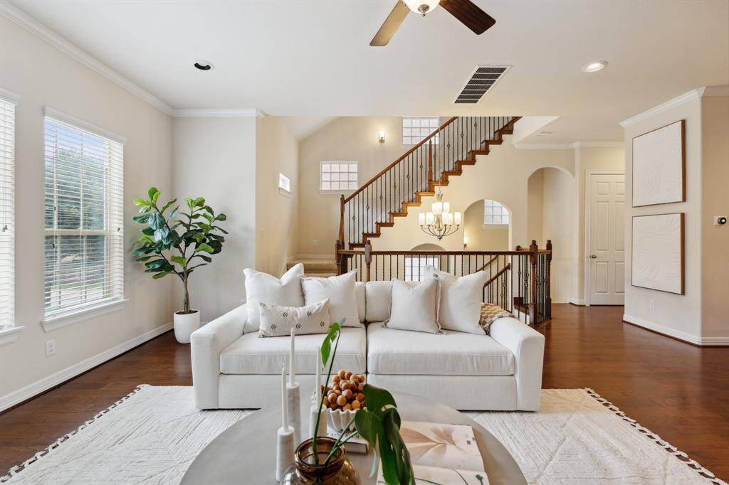 The living room is complemented by the staircase set just behind it—offering both visual appeal and smart functionality.