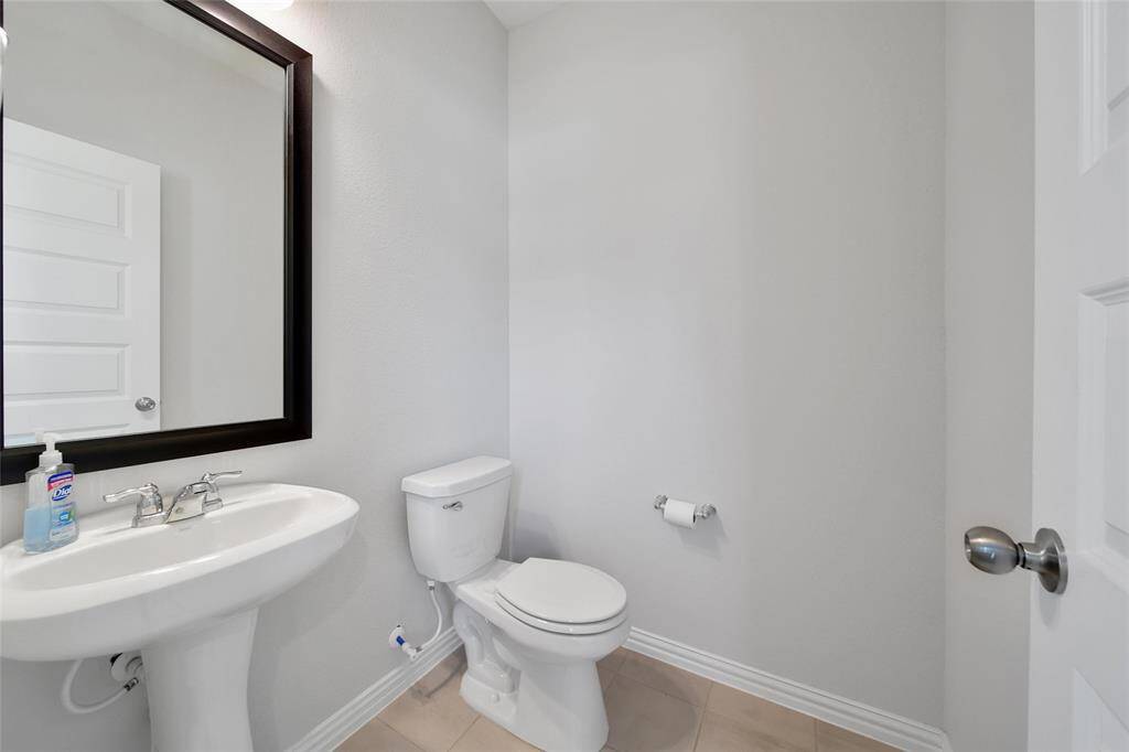 Convenient half bath located just off the front entry with full baths located upstairs.