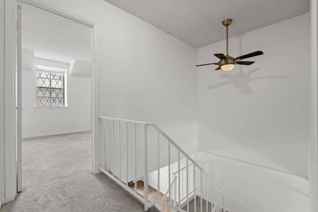 Welcome to the 2nd floor landing with a glimpse to the primary retreat.