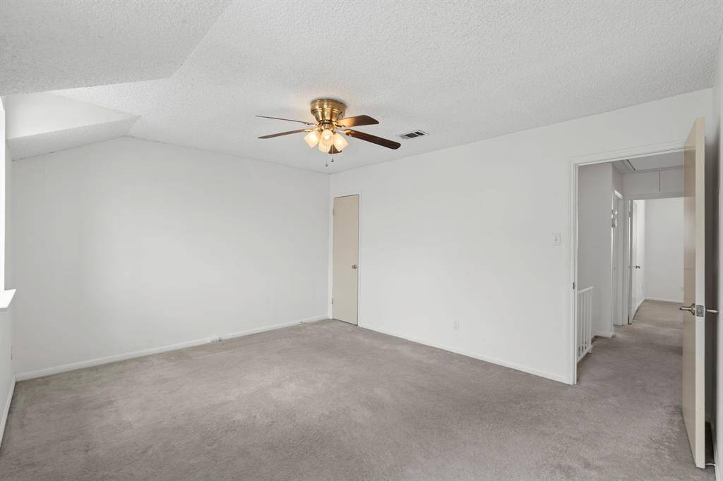 The primary bedroom feels so spacious thanks to the vaulted ceiling.