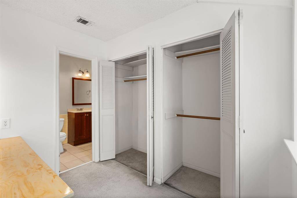 The primary bathroom offers an intelligent design, featuring a semi-private vanity nook that's open for conversation, and the added luxury of two dedicated primary closets. This means exceptional storage, superior organization, and a truly uncluttered, tranquil space for all your personal needs.