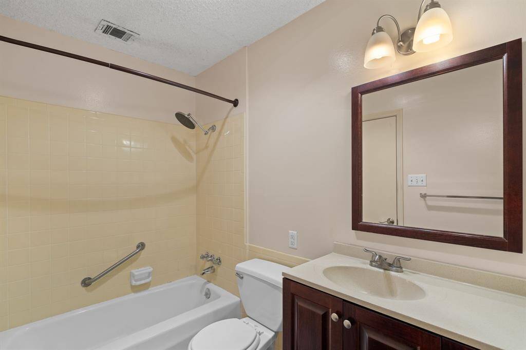 A sanctuary within a suite. Discover the thoughtfully designed tub-shower, tucked away in a secluded nook, creating a peaceful retreat in this updated primary bathroom.