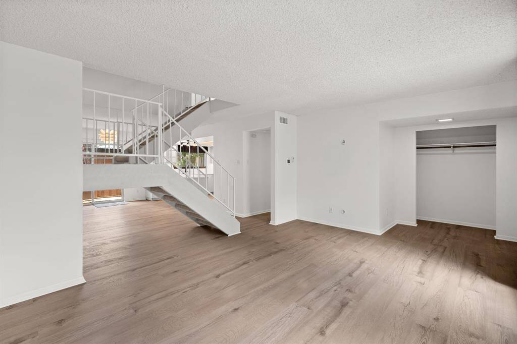 Open design creates an airy space, connecting the living to dining room and kitchen.