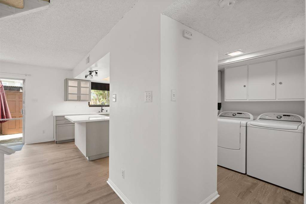 Washer and Dryer are tucked away by the half bath for ultimate privacy.